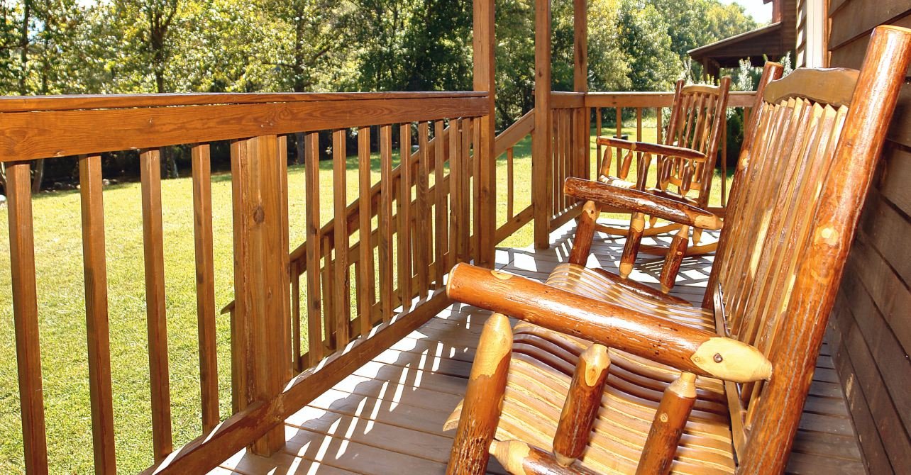 Wooden rocking chairs on the porch of a cabin rental in Cocke County, TN.